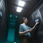 female-it-technician-managing-server-in-data-center